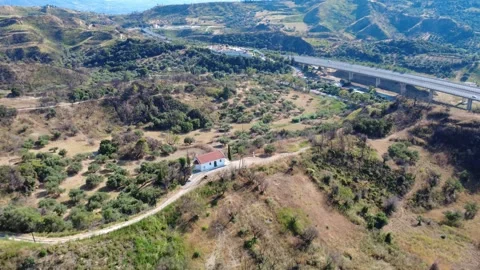 Aerial panoramic wide angle view of a chapel near a busy highway bridge Stock Footage 344105366