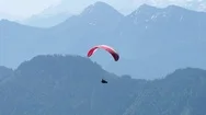 Aerial Of Parachutist Flying Over The Forest And The Mountains Stock Footage