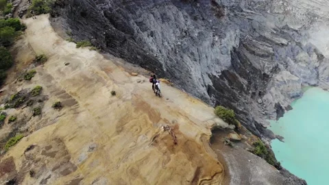 Aerial Parallax of Friends Overlooking Java Indonesia Sulfur Volcano Kawah Ijen Stock Footage 142300387