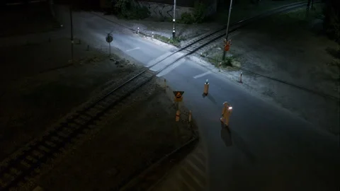 Aerial parallax of spaceman examining object by train track at night Stock Footage 296571651