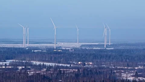 Aerial parallax view of motionless wind turbines in snowy winter landscape with Stock Footage 327497332