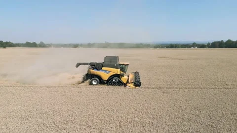 Aerial parallel tracking view clip of a combine harvester harvesting wheat grain Stock-Footage 205330098