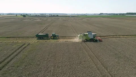 Aerial parallel tracking view clip of a combine harvester harvesting wheat Stock-Footage 205330262