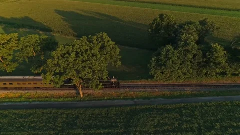 Aerial Parallel View of A Steam Passenger Train Passing Thru Corn Fields Video stock 174488686