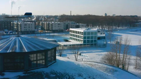 Aerial past Estonian flag colored windsock opening onto eu-Lisa building Stock Footage 102027341