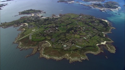 Aerial of patch field landscape surrounded by sea, St Mary's Island Stock Footage 108589364