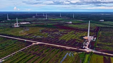 Aerial of Patchwork Farm Fields and Oil Stacks in Bright Daylight Stock Footage 317745895