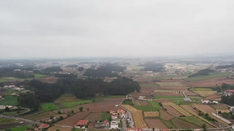 Aerial - patchwork fields and forest clusters in the Minho region north Portugal Stock Footage 311840625