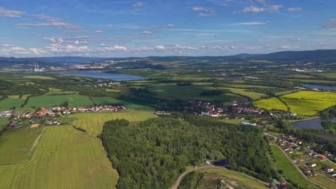 Aerial patchwork landscape of green fields, lakes, and small villages with Stock Footage 346261657