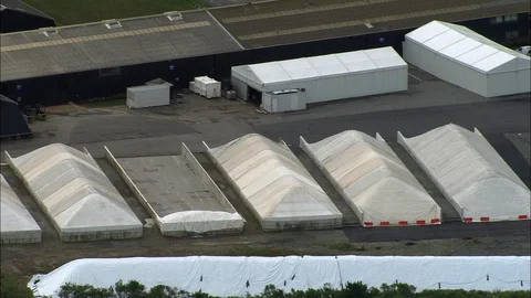 Aerial of patchwork paddy field and warehouse, Salt Beds Stock-Footage 108591710