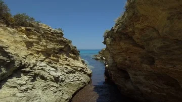 Aerial path across the cliff edge and turquoise water sea, Corsica Stock Footage 85468099