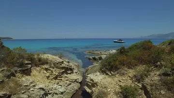 Aerial path across the cliff edge and turquoise water sea, Corsica Stock-Footage 85556304