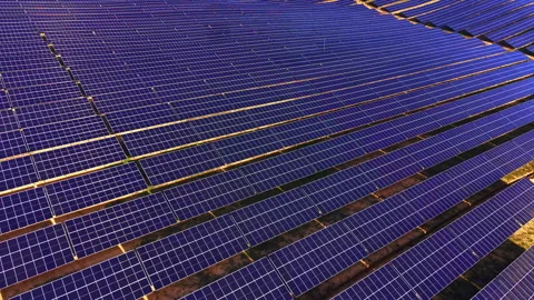 Aerial pattern of blue solar modules across open field, Bulgaria Stock Footage 336724036
