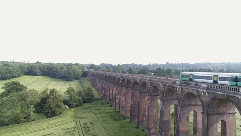Aerial pedestal shot - Ouse Valley Rail Viaduct in England, UK with train Stock Footage