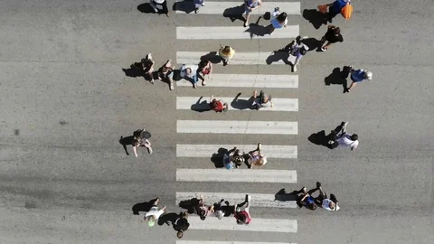 Aerial. People crowd on pedestrian crosswalk. Top view. Stock Footage