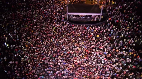 AERIAL: People partying on an outdoors music concert Stock Footage