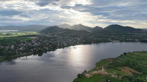 Aerial of Perfume River reflecting sunset mountain light 4K Stock Footage 339863428
