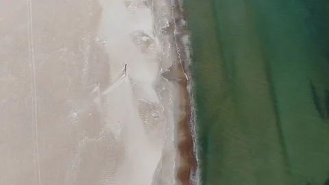 Aerial perpendicular view of a silent beach in the morning Stock Footage 130104241