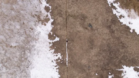 Aerial of person walking on the narrow path on a landscape covered with snow Stock Footage