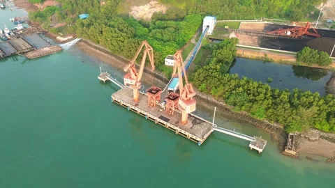 Aerial perspective of an active maritime cargo terminal with heavy lifting .. Stock Footage 337281009