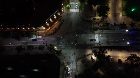 Aerial perspective of a bustling intersection at night, featuring illuminated Stock Footage 342921080