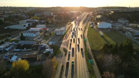 Aerial perspective captures a bustling highway at sunset, highlighting vehicles Video stock 335890822