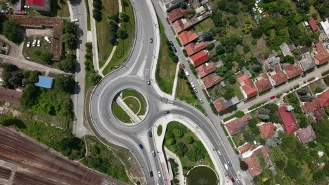 An aerial perspective captures a busy roundabout and connecting roads, bordered Stock Footage 337944861