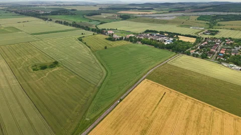 An aerial perspective captures the diverse patchwork of agricultural fields and 動画素材 337962876