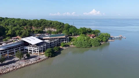 Aerial perspective captures a modern coastal restaurant by the sea 스톡 동영상 344953767