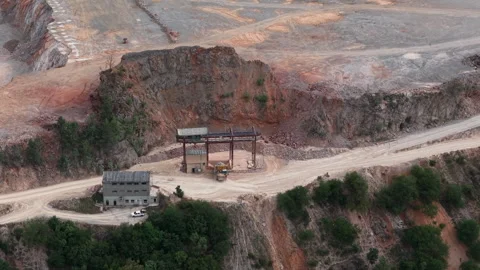 An aerial perspective captures stone mining infrastructure and heavy machinery Stock Footage 340896989