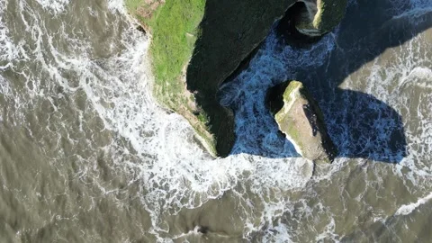 An aerial perspective capturing a dramatic coastal scene with rugged cliffs Stock Footage 296009321
