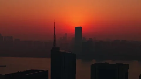 Aerial perspective capturing the sunrise over Hangzhou, China. Silhouetted Stock-Footage 325080516