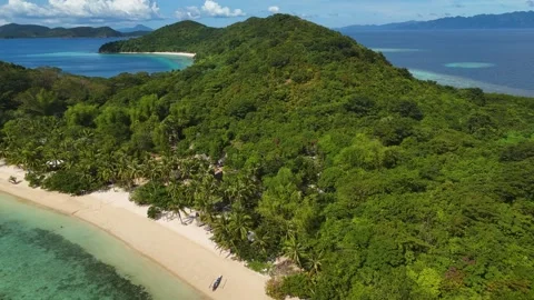 Aerial perspective of Coco Beach, showcasing its tranquil beauty and vibrant Stock Footage 295913746