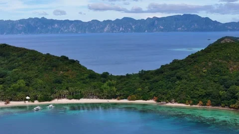 Aerial perspective of Coco Beach, showcasing its tranquil beauty and vibrant Stock Footage 295914898