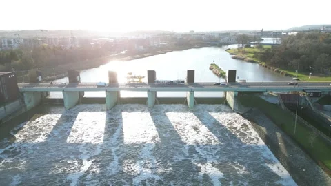 Aerial perspective of a dam over a river, highlighting water flow Stock Footage 321402780