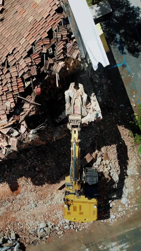 Aerial perspective of a demolition scene where an excavator machinery is engaged Stock Footage 314111457