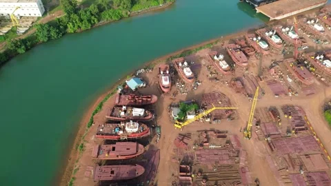 Aerial Perspective of a Dynamic Riverside Shipyard Specializing in Robust M.. Video stock 325288795