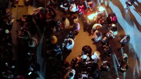 Aerial perspective highlights fire show weaving through the crowd Vídeo Stock 332097060