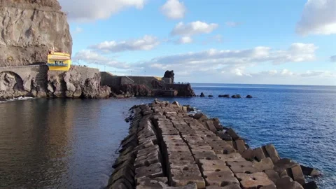 Aerial perspective of the historic Ponta do Sol pier, featuring a breakwater Stock Footage 341993571