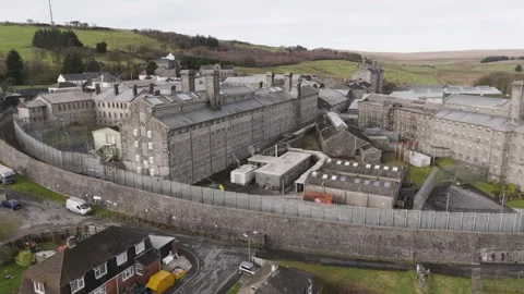 Aerial perspective of HM Prison Dartmoor’s fortified stone structure and Stock Footage 295831123