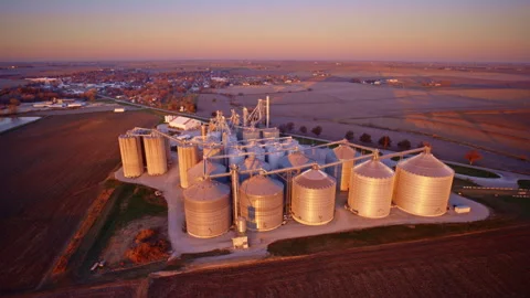 Aerial perspective of a huge grain elevator surrounded by silos and bins Stock Footage 328944148