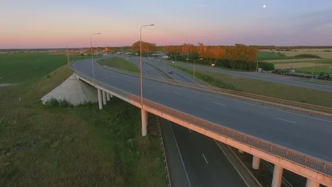 Aerial perspective of interstate commuter traffic crossing bridge on clear Stock Footage 77490090