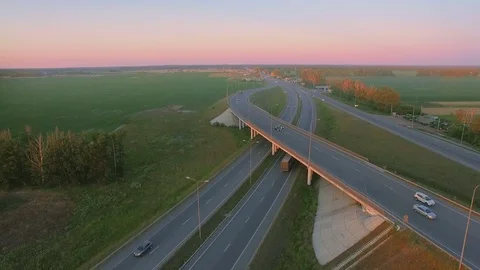 Aerial perspective of interstate commuter traffic crossing bridge on clear Stock Footage 77490155
