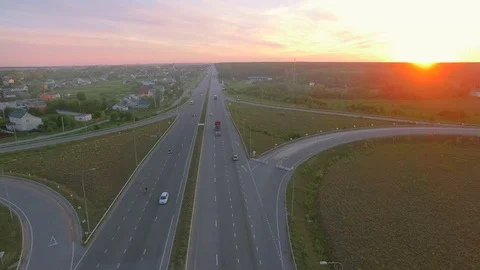 Aerial perspective of interstate commuter traffic crossing bridge on clear Stock Footage 77490233