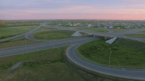 Aerial perspective of interstate commuter traffic crossing bridge on clear Stock Footage 77490288