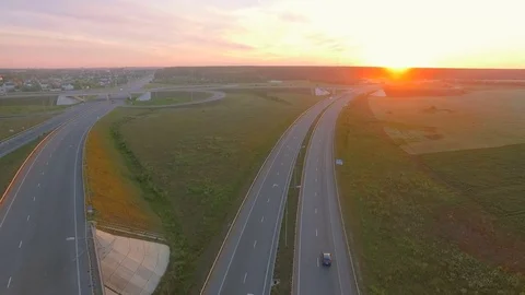 Aerial perspective of interstate commuter traffic crossing bridge on clear Stock Footage 77490350