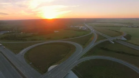 Aerial perspective of interstate commuter traffic crossing bridge on clear Stock Footage 77490550