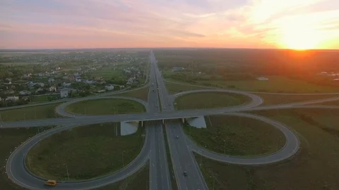 Aerial perspective of interstate commuter traffic crossing bridge on clear Stock Footage 77490623