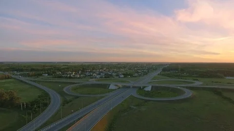 Aerial perspective of interstate commuter traffic crossing bridge on clear Stock Footage 77490714