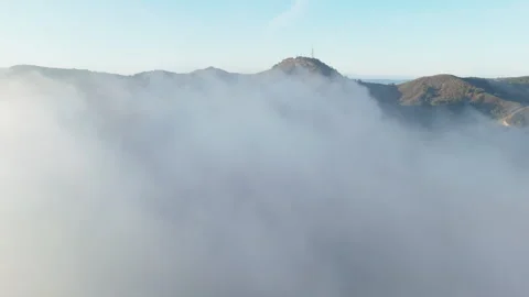 An Aerial Perspective of the Majestic Mountains Enveloped in a Mystical Foggy Stock Footage 305469341